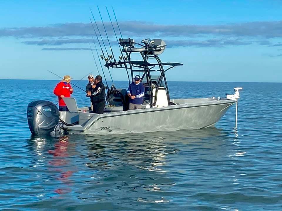 A couple taking a selfie on their pathfinder boat.