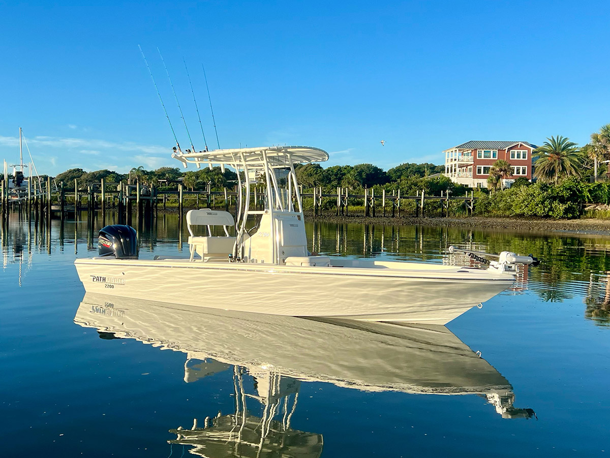 Pathfinder boat in calm water with mirror reflection.